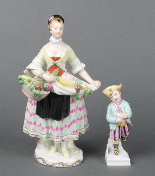 A 20th Century Austrian porcelain figure of a lady holding a basket of fruits and vegetables 8 1/2" together with a KPM figure of a boy ice skater 4 1/2" 