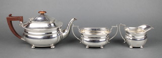 An Art Deco silver 3 piece tea set with gadroon rims and fruitwood handles, London 1936, gross 1050gr