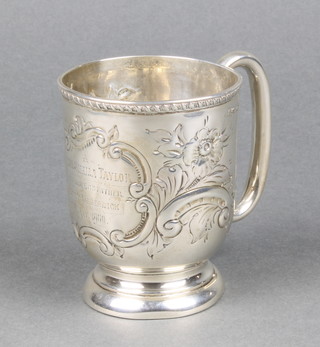 A Victorian repousse silver mug with floral and scroll decoration and inscription, Chester 1899, 71 grams, 3" 