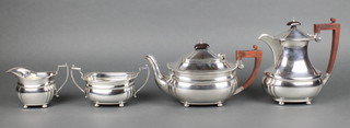 A 4 piece silver tea and coffee set with gadrooned decoration and fruitwood handles, raised on ball feet Birmingham 1961, gross 1536g 
