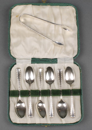 A cased set of 6 fancy silver coffee spoons, Sheffield 1946 together with a pair of silver nips, 84g 