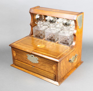 An Edwardian inlaid oak silver plated mounted 3 bottle tantalus, the 2 flaps revealing 5 glasses, the base with a fitted drawer enclosing cards and markers 13"h x 13 1/2"w x 11"d
