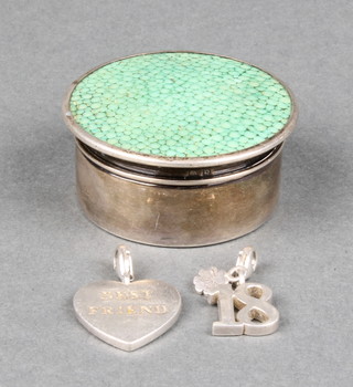 A silver and shagreen circular pill box, Birmingham 1929 1 1/2" together with 2 silver charms 