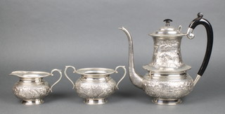 A 3 piece Indian sterling silver repousse tea set comprising teapot, milk jug and sugar bowl, profusely decorated with figures and animals in extensive landscapes, gross 54 ozs