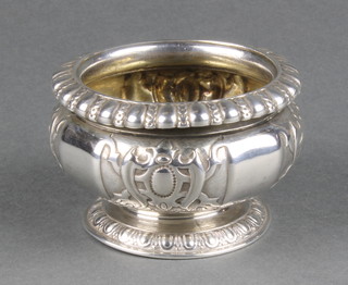 A Victorian silver pedestal table salt with repousse decoration, London 1877 3" 182 grams
