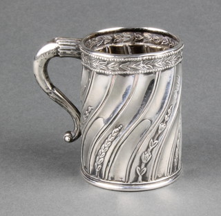 A Victorian silver repousse mug with spiral decoration bearing an inscription and date 1984, London 1883, 102 grams