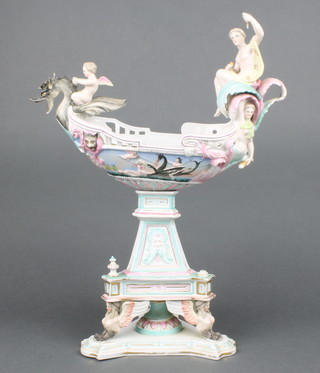 A 19th Century German porcelain centrepiece in the form of a boat surmounted by a semi-clad classical lady and a cherub, the boat with battle scenes on a trefoil stand with winged figures 14" 