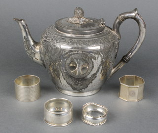 Four silver napkin rings 82gr and a silver plated tea pot