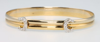 Cartier, an 18ct yellow 2 colour gold expanding bracelet set with 2 initial C's mounted with 9 diamonds, signed Cartier no.237876, gross weight 18.2 grams 6.5cm wide