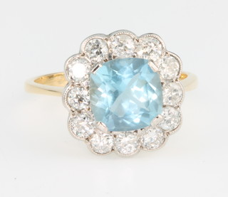 An 18ct yellow gold aquamarine and diamond cluster ring, the centre stone approx. 1.75ct surrounded by 12 brilliant cut diamonds, size O 