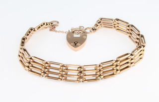 A 9ct yellow gold bracelet with ditto padlock, 14 grams