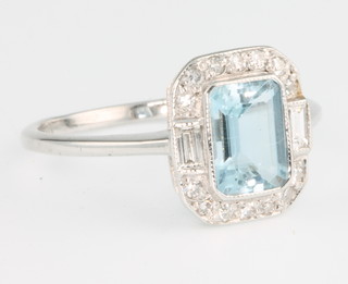 An 18ct white gold aquamarine and diamond Art Deco style cluster ring, the centre stone approx. 1.1ct, size M 