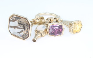 3 gilt hardstone set seals together with a ditto watch key on a fancy ring 