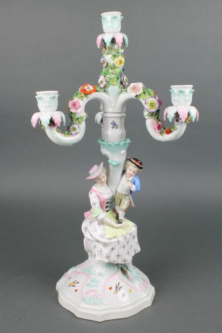 A 19th Century Continental porcelain candelabrum, the base with a child standing on a lady's lap decorated with insects and birds, having a later 4 light candle holder 20" 