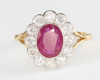 An 18ct yellow gold ruby and diamond cluster ring, the centre stone approx. 1.7ct surrounded by 12 brilliant cut diamonds, size P 