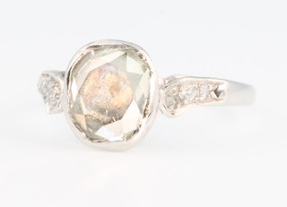 A white gold diamond ring with mine cut stone, the shoulders with 3 brilliant cut stones, size L