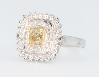 A 14ct white gold fancy yellow gold diamond cluster ring, the centre cushion cut stone approx 0.8ct surrounded by 2 tiers of brilliant cut diamonds 0.6ct, size Q, with certificate 