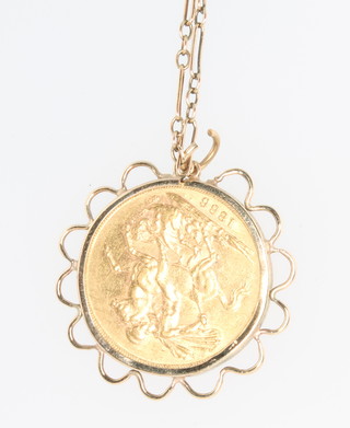 An 1886 sovereign contained in a 9ct gold mount, a gilt chain and a ditto fox head tie pin