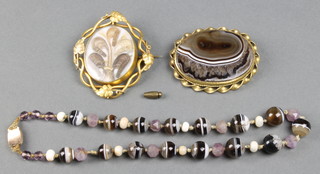 A Victorian mourning brooch, a hardstone bead necklace and ditto brooch 