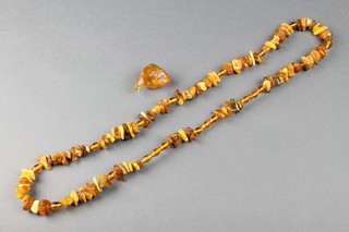 A treated natural amber bead necklace 34", a ditto pendant