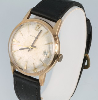 A gentleman's 9ct yellow gold wristwatch with calendar dial, inscribed Garrard on a leather strap, boxed 