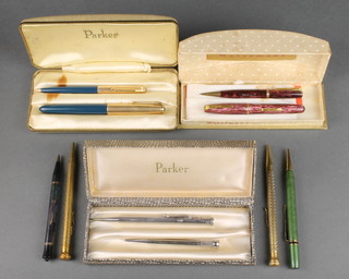 A boxed blue Parker 51 fountain pen and a ditto propelling pencil, a boxed pink marbled Waterman 512V fountain pen and propelling pencil and 6 other propelling pencils