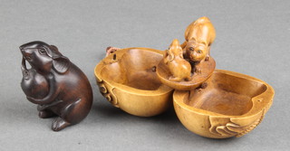 A modern fruitwood netsuke in the form of a seated mouse eating a fruit, bearing a signature 2" together with an articulated netsuke, an opening bag revealing a cat and mouse 