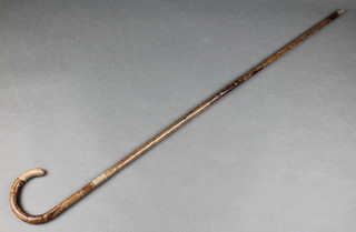 A silver mounted walking stick with scroll decoration 