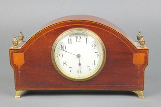 A French bedroom timepiece with enamelled dial and Arabic numerals contained in an arched inlaid mahogany case