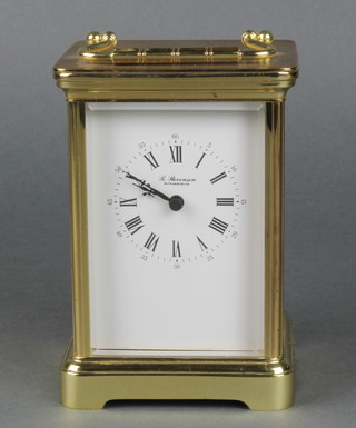 An R Stevenson quartz operated carriage clock contained in a gilt metal case