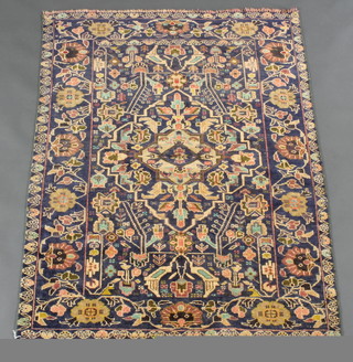 A contemporary Persian blue ground Belouche rug with central medallion 62" x 35" 
