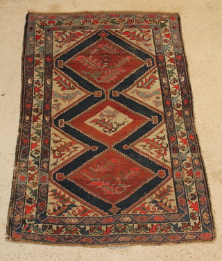 A Kurdish rug with brown and blue ground and 3 stylised diamonds to the centre 76" x 50" (in wear) 