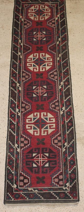 A red and blue ground Afghan runner with 6 octagons to the centre 111" x 28"