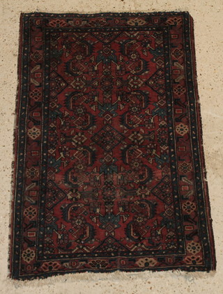 A red and blue ground Persian rug with geometric designs 48" x 30" 