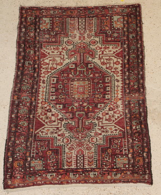 A Caucasian rug with diamond shaped medallion to the centre 57" x 40" 