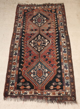 An Afghan brown and black ground rug with 2 diamonds to the centre 101" x 55" 