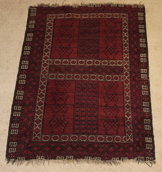 A red ground Afghan rug with rectangular panels to the centre 81" x 60" 