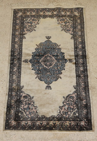 A cream ground Bokhara rug with central medallion 64" x 30" 