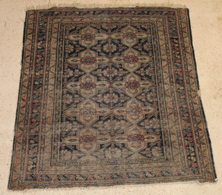 A Caucasian style rug with 10 stylised octagons to the centre, in wear 57" x 59"