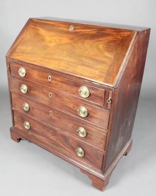 A Georgian mahogany bureau, the fall front revealing a fitted interior above 4 long graduated drawers with oval brass drop handles, raised on bracket feet 42"h x 36"w x 20 1/2"d
