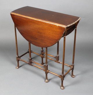 An Edwardian Chippendale style mahogany oval drop flap spiders leg table, raised on pad feet 29"h x 29" x 12" when closed by 34 1/2" when opened