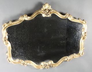 A shaped plate mirror contained in a decorative gilt frame 31"h x 40"w