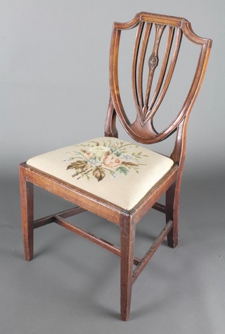 A 19th Century mahogany shield back chair with Berlin wool work seat, raised on square tapering supports 