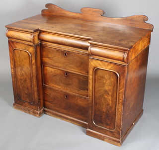 A Victorian mahogany inverted breakfront sideboard with raised shaped back, the centre secret drawer fitted a reading fack flanked by 2 secret drawers above 3 long drawers flanked by cupboards enclosed by arched panelled doors 38"h x 46"w x 22"d 