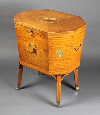 A Sheraton style octagonal satinwood wine cooler with brass drop handles, having a crossbanded top and painted panels of roses, raised on square supports  29 1/2"h x 25"w x 19 1/2"d 