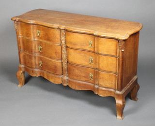 A Continental oak chest of serpentine outline fitted 6 short drawers, raised on cabriole supports 27"h x 44"w x 15"d 