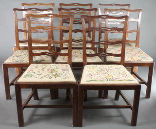 A set of 8 mahogany London ladder back chairs with upholstered drop in seats, raised on square supports with H framed stretchers 