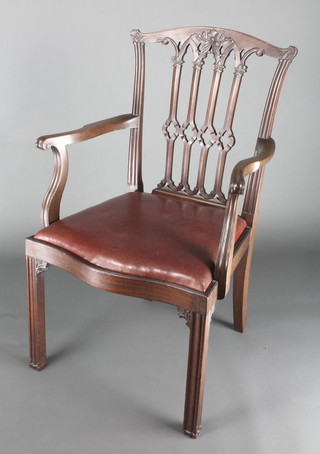 A 19th Century Chippendale style carver chair with tracery back and upholstered drop in seat, raised on square supports 