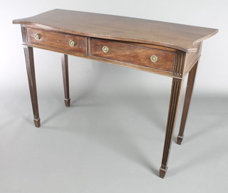 A Georgian style side table of serpentine outline fitted 2 drawers with ring drop handles, raised on square tapered fluted supports, spade feet 33"h x 46"w x 19 1/2"d 
