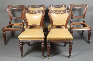 In the manner of Gillows, a set of 6 George IV mahogany dining chairs with pierced and waisted backs, upholstered in brown material, raised on turned and reeded supports 